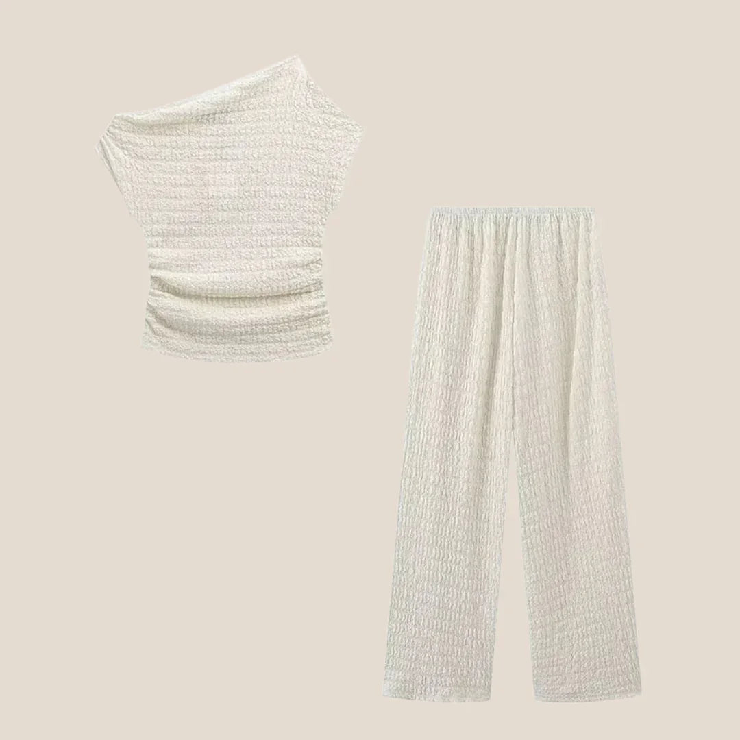 Textured cream two-piece set with off-shoulder top and wide-leg pants by Olivia The Label